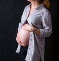 Pregnant women belly dressed in grey shirt Royalty Free Stock Photo