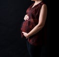 Pregnant women belly dressed in red blouse Royalty Free Stock Photo