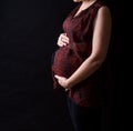 Pregnant women belly dressed in red blouse Royalty Free Stock Photo