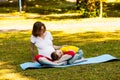 Pregnant woman with her son relaxing in park Royalty Free Stock Photo