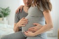 Pregnant woman and her husband holding hand together. Family is happy in anticipation of baby. Royalty Free Stock Photo