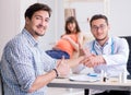 Pregnant woman with her husband visiting the doctor in clinic Royalty Free Stock Photo