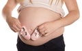 Pregnant women holding pair of pink shoes Royalty Free Stock Photo