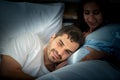 Pregnant woman with husband in bedroom with the atmosphere of having fun talking