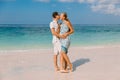 Young pregnant woman with husband at paradise beach. Happy couple at tropical island