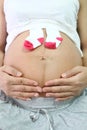 Pregnant women keep sock placed on belly.