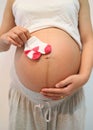 Pregnant women keep sock placed on belly.