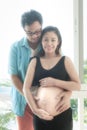 Pregnant women and man with hug on belly.Special gift for mom and dad