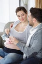 pregnant woman and man holding baby shoes Royalty Free Stock Photo