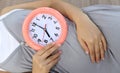 Pregnant women show clock on her belly to tell the time. Royalty Free Stock Photo