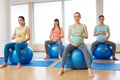 Pregnant women sitting on exercise balls in gym Royalty Free Stock Photo