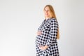 Pregnant woman standing on scales to control weight gain Royalty Free Stock Photo