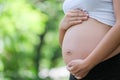 Pregnant women support the stomach by hand