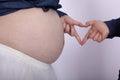 Pregnant women, two pairs of heart-shaped hands
