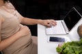 Pregnant women are using laptops for internet use. Find medical information for children who are about to be Royalty Free Stock Photo