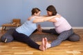 Pregnant women working out idoing Seated straddle posture, Upavishtha Konasana