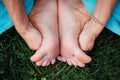 Pregnant yoga in the lotus position. in the park on the grass, doing exercises, stretching, outdoor, . feet close-up