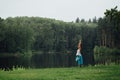 Pregnant yoga prenatal maternity doing different exercises. in the park on the grass, breathing, stretching, statics. Royalty Free Stock Photo