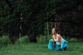 Pregnant yoga prenatal maternity doing different exercises. in the park on the grass, breathing, stretching, statics. Royalty Free Stock Photo