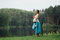 Pregnant yoga prenatal maternity doing different exercises. in the park on the grass, breathing, stretching, statics. Royalty Free Stock Photo