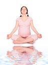 Pregnant yoga woman on beach Royalty Free Stock Photo