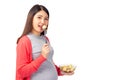 Pregnant young asian woman eating fruit salad fresh, Fruit salad is healthy food for baby or fetus. Pregnant mother hold blow of