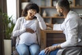 Pregnant black woman feeling bad, visiting doctor at clinic Royalty Free Stock Photo