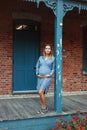 Pregnant young Caucasian woman wearing long blue dress and rustic country hat in park outside. Royalty Free Stock Photo