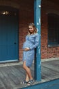 Pregnant young Caucasian woman wearing long blue dress and rustic country hat in park outside. Royalty Free Stock Photo