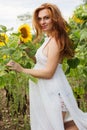 Pregnant young girl in sunflowers field Royalty Free Stock Photo