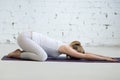 Pregnant young woman doing prenatal Child Yoga Pose, Balasana