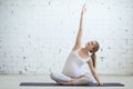 Pregnant young woman doing prenatal yoga. Side stretching Royalty Free Stock Photo