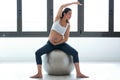 Pregnant young woman doing relax exercises with a fitness pilates ball at home Royalty Free Stock Photo