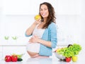 Pregnant young woman eating apple Royalty Free Stock Photo