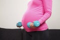 Pregnant young woman exercising with training weights indoor Royalty Free Stock Photo