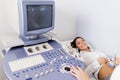 Pregnant young woman at gynecologist having examined with ultras