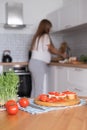 Pregnant young woman preparing healthy sandwiches with microgreens and vegetables at home in the kitchen Royalty Free Stock Photo