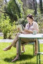 Beautiful pregnant young woman reading newspaper outdoors Royalty Free Stock Photo