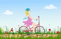 Pregnant young woman riding bike on spring flowering field. Royalty Free Stock Photo