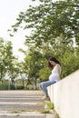 Young pregnant woman looking her belly sitting in the street Royalty Free Stock Photo