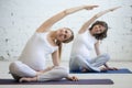 Pregnant young women doing prenatal yoga. Bending in easy pose Royalty Free Stock Photo
