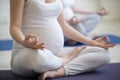 Pregnant young women doing prenatal yoga. Close-up of torso Royalty Free Stock Photo