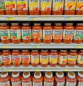Prego Italian sauce jars with various flavors stacked on supermarket shelves.