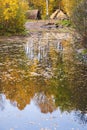 Prehistoric huts at a beach with reflection at autumn colors in the water Royalty Free Stock Photo