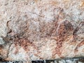 Prehistoric painting of men in actions on rock painted with red colour by human who live in the area over thousand year ago Royalty Free Stock Photo