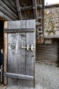 Prehistoric wooden door with closure. Open-air archaeological museum presenting archaeological finds and replicas of pile-dwelling