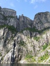 Preikestolen or Pulpit Rock. Bottom view of a giant cliff 604 m high above the Lysefjord, Norway. View Royalty Free Stock Photo
