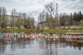 Group of people ice bathing together in the cold water of a lake in Preili, Latvia