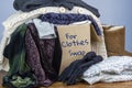 Preloved clothes in a box marked for Clothes Swap Royalty Free Stock Photo