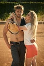 Prelude - couple in love. Girlfriend with tennis racket hug boyfriend Royalty Free Stock Photo